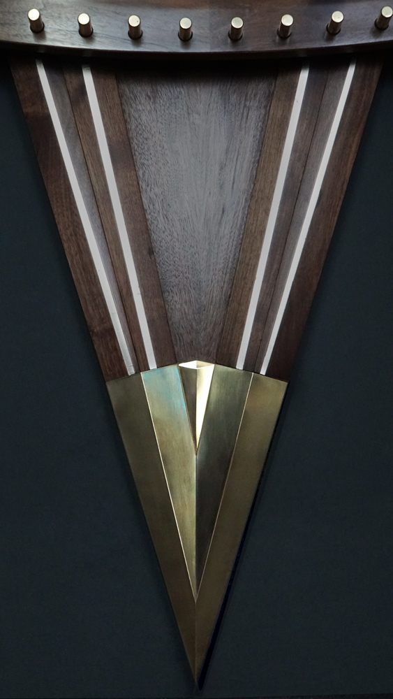 Large wooden wall sculpture made from walnut, brass and gold leaf, featuring three slow-rotating circular wheels set within a geometric framework. Handcrafted with fine cabinetmaking techniques, the piece is motorized for silent, continuous movement.